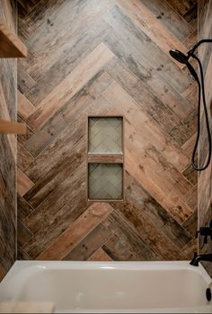 a bath tub sitting next to a wooden wall