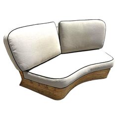 a white couch sitting on top of a wooden frame