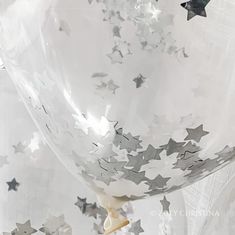 white and silver balloons with stars on them