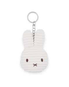 a white rabbit keychain with brown eyes and ears on it's face