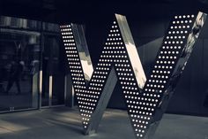 the letters w are lit up in front of a building