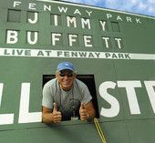 a man sitting in the dugout at a baseball game with his hand up to his face