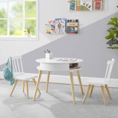 a white table and two chairs in front of a potted plant on the floor