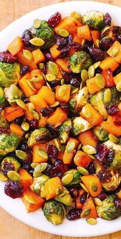 Roasted Butternut Squash, Brussels sprouts, Pumpkin Seeds, Dried Cranberries on a white plate Veggies Thanksgiving, Maple Butternut Squash, Resep Vegan, Brussels Sprouts Salad, Resep Salad, Sprouts Salad, Holiday Side, Roasted Brussels Sprouts, Brussel Sprout Salad