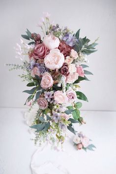 a bouquet of flowers sitting on top of a white table