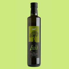 a bottle of extra virgin olive oil on a green background