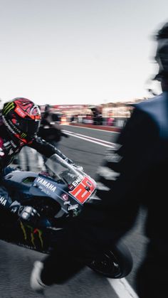 a man riding a motorcycle on top of a race track