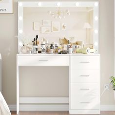 a white vanity with lights on it and a mirror above the counter in a bedroom