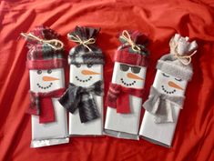 three snowmen are wrapped in white paper