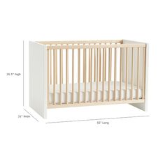 a white crib with measurements for the bed