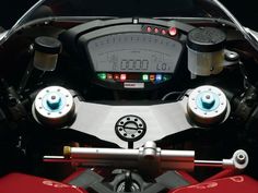 the front view of a red motorcycle with digital gauges