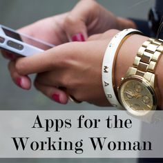 a close up of a person holding a cell phone and wearing bracelets on her wrist