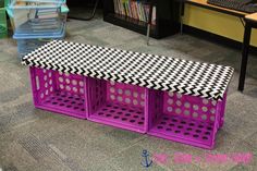 a desk with three purple bins and a black and white checkered top