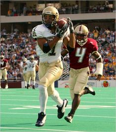 a football player running with the ball in his hand