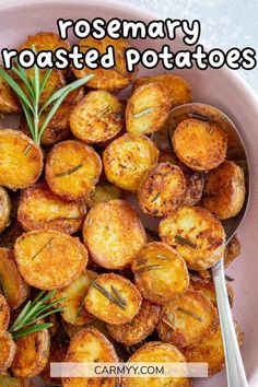 rosemary roasted potatoes in a pink bowl with a spoon on the side and text overlay reading rosemary roasted potatoes