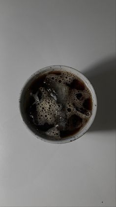 a cup filled with liquid sitting on top of a table