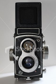 an old fashioned camera on a white background