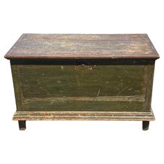 an old wooden chest with no lid on it's legs and one drawer open