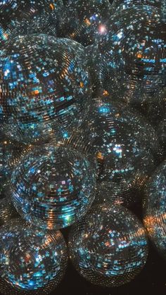 many shiny disco balls are stacked together