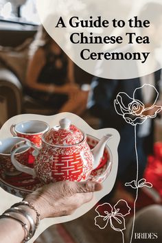 a person holding a red tea pot with white flowers on it and the title, a guide to the chinese tea ceremony