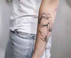 a woman's arm with a flower tattoo on the left side of her arm