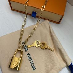 Louis Vuitton Lv Lock And Key Pendant Necklace New, Excellent Condition Lv Padlock On A 20” Paperclip Clasp Chain Two (2) Keys To Unlock Gold-Plated Polished Brass Adjustable Size, Versatile Wear Styles Comes With Pouch And Louis Vuitton Gift Box Perfect Statement Piece To Compliment Any Outfit! Makes A Great Gift! Lv Lock Necklace, Louis Vuitton Gift, Repurposed Necklace, Louis Vuitton Gifts, Louie Vuitton, Key Pendant Necklace, Button Necklace, Louis Vuitton Jewelry, Lock Necklace