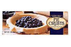 a box of trader joe's pie crusts with blueberries in the bowl