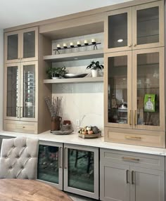 a kitchen with wooden cabinets and white counter tops, along with a dining room table