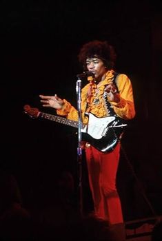 a man with an electric guitar on stage