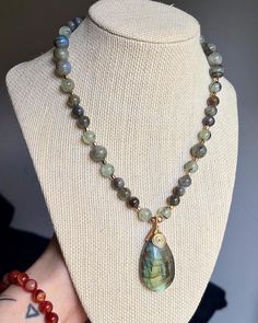 This beautiful piece features a super flashy beaded necklace featuring a gorgeous multi colored labradorite pendant, wire wrapped with tarnish resistant wire. It is paired with prehnite and flashy labradorite bead.  This necklace is amazing for grounding yourself and connecting with nature and nuturing your mind and spirituality.  This necklace is 16 inches in length and adjustable up to 20 inches. It is secured with a stainless steel lobster clasp and stainless steel findings.  Tips for Care -Put on Carefully!  -Store hanging horizontally away from sunlight!  -Avoid showering, sleeping, and swimming in your jewelry  -Keep from small children or animals *Handmade *One of a kind *Ships 3-5 Days Labradorite Pendant Necklace, Labradorite Beaded Necklaces For Jewelry Making, Hand Wrapped Labradorite Bead Jewelry, Labradorite Gemstone Bead Crystal Necklaces, Labradorite Gemstone Crystal Necklaces With Round Beads, Gift Labradorite Beaded Necklace With Adjustable Fit, Labradorite Beaded Necklace, Adjustable Labradorite Gemstone Beaded Necklaces, Handmade Labradorite Bead Necklace