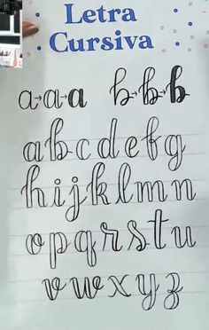 there is a handwritten alphabet written in cursive writing on a piece of paper