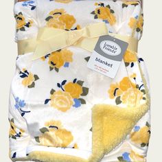 a blanket with yellow flowers on it and a tag attached to the back of it