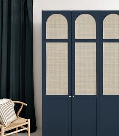 a blue armoire sitting next to a window