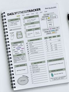 the daily fitness tracker is on top of a notebook