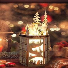 a lit up christmas lantern sitting on top of a table