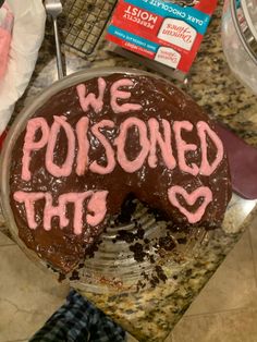 a chocolate cake with pink writing on it