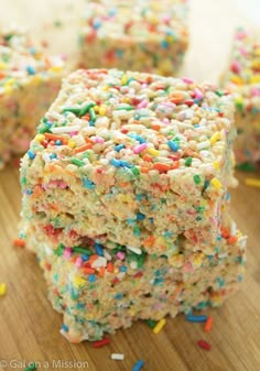 sprinkle covered rice krispy treats are stacked on top of each other and ready to be eaten