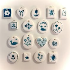 a collection of ceramic ornament designs on a white surface, including flowers and birds