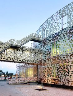 an artistic building with intricate patterns on the outside and inside, as well as glass windows