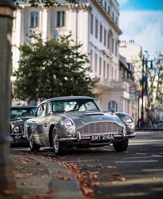 an old car is parked on the side of the road