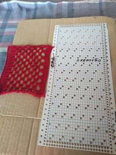 a red piece of cloth sitting on top of a cardboard box