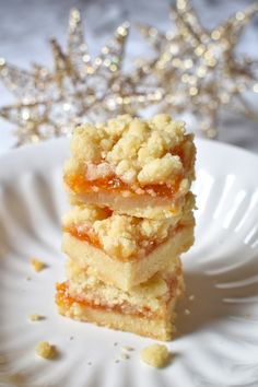 three pieces of cake sitting on top of a white plate next to a silver star