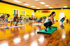 a group of people doing yoga in a gym