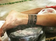 a man laying on the ground with his arm wrapped in plastic wrap and tattooing