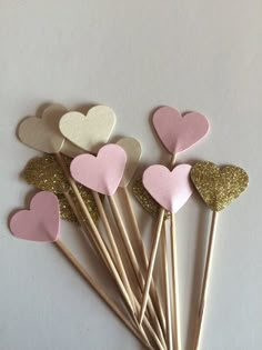 pink and gold heart picks with glitter hearts on them for valentine's day party favors