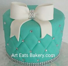 a green cake with white bows on top