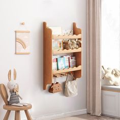 a wooden shelf with books and toys on it in a child's playroom