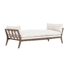 a white chaise lounger with two pillows on the back and one arm upholstered