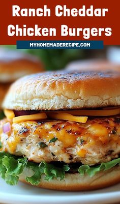 a grilled chicken burger with cheese and lettuce on a bun is shown