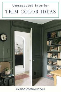 a living room with green walls and a clock on the wall in front of it